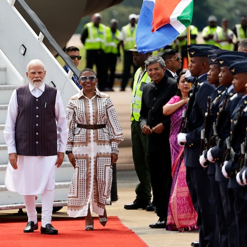 Indian Prime Minister Narendra Modi, left, is welcomed by Khumbudzo Ntshavheni, Minister in the Presidency on his arrival at the Air Force Base Waterkloof, near Pretoria, South Africa, Friday Nov. 21, 2025, ahead of the G20 Summit. (Kim Ludbrook/Pool Photo via AP)