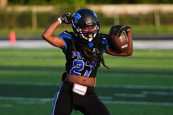 Detroit Prowl's Milana Stromile celebrates an interception against the Lansing Legacy during an AWFL women's football game in Allen Park, Mich., Saturday, May 10, 2025. (AP Photo/Paul Sancya)
