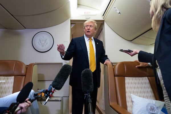 President Donald Trump speaks with reporters on Air Force One after landing in Suffolk, Eastern England, last Wednesday. (Alex Brandon/AP)