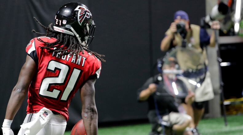 Atlanta Falcons cornerback Desmond Trufant (21) scores a touchdown after Atlanta Falcons outside linebacker Vic Beasley (44) caused Green Bay Packers quarterback Aaron Rodgers (12) to fumble during the second of an NFL football game, Sunday, Sept. 17, 2017, in Atlanta. (AP Photo/David Goldman)