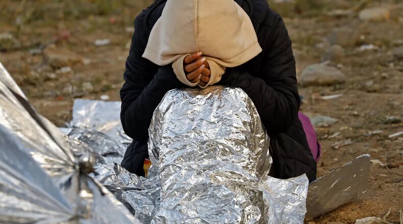 Migrants at the border between San Diego and Tijuana keep warm using Mylar blankets at night. Some have been camped there for days waiting for Border Patrol agents to pick them up and take them to be processed. (Carolyn Cole/Los Angeles Times/TNS)