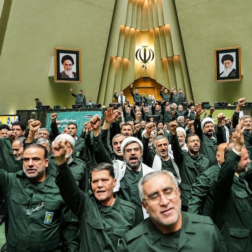 In this handout photo released by the Islamic Consultative Assembly News Agency (ICANA) Iranian lawmakers chant slogans as they wear the Revolutionary Guard's uniform in a session of parliament, in Tehran, Iran, Sunday, Feb. 1, 2026. (Hamed Malekpour/ICANA via AP)