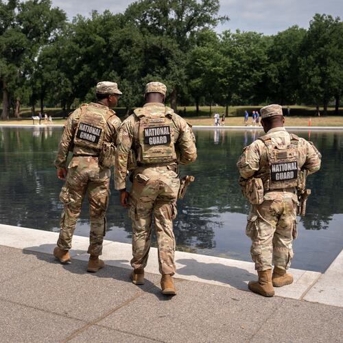 National Guard members look at the Lincoln Memorial Reflecting Pool, Monday, June 22, 2026, in Washington. (AP Photo/Mark Schiefelbein)