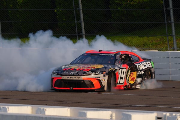 Chase Briscoe celebrates with a burnout after winning a NASCAR Cup Series auto race at Pocono Raceway, Sunday, June 22, 2025, in Long Pond, Pa. (AP Photo/Derik Hamilton)