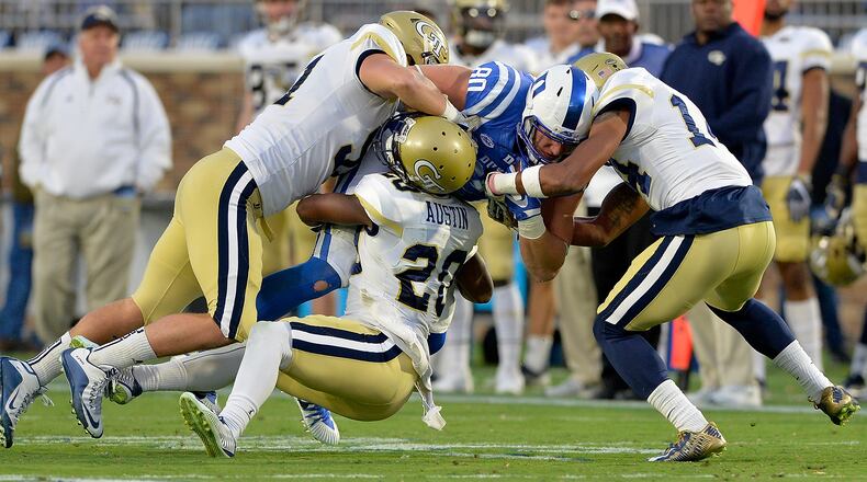 DURHAM, NC - NOVEMBER 18: Brant Mitchell #51, Lawrence Austin #20 and Corey Griffin #14 of the Georgia Tech Yellow Jackets tackle Daniel Helm #80 of the Duke Blue Devils during their game at Wallace Wade Stadium on November 18, 2017 in Durham, North Carolina. (Photo by Grant Halverson/Getty Images)