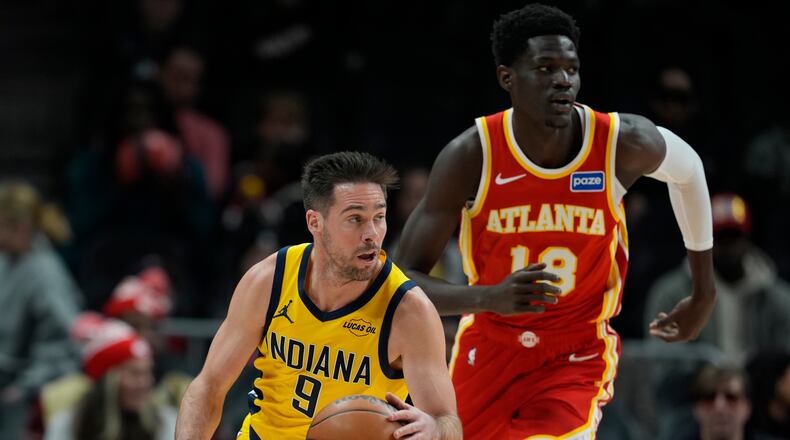 Indiana Pacers guard T.J. McConnell (9) moves against Atlanta Hawks forward Mouhamed Gueye (18) during the first half of an NBA basketball game, Monday, Jan. 26, 2026, in Atlanta. (AP Photo/Mike Stewart)