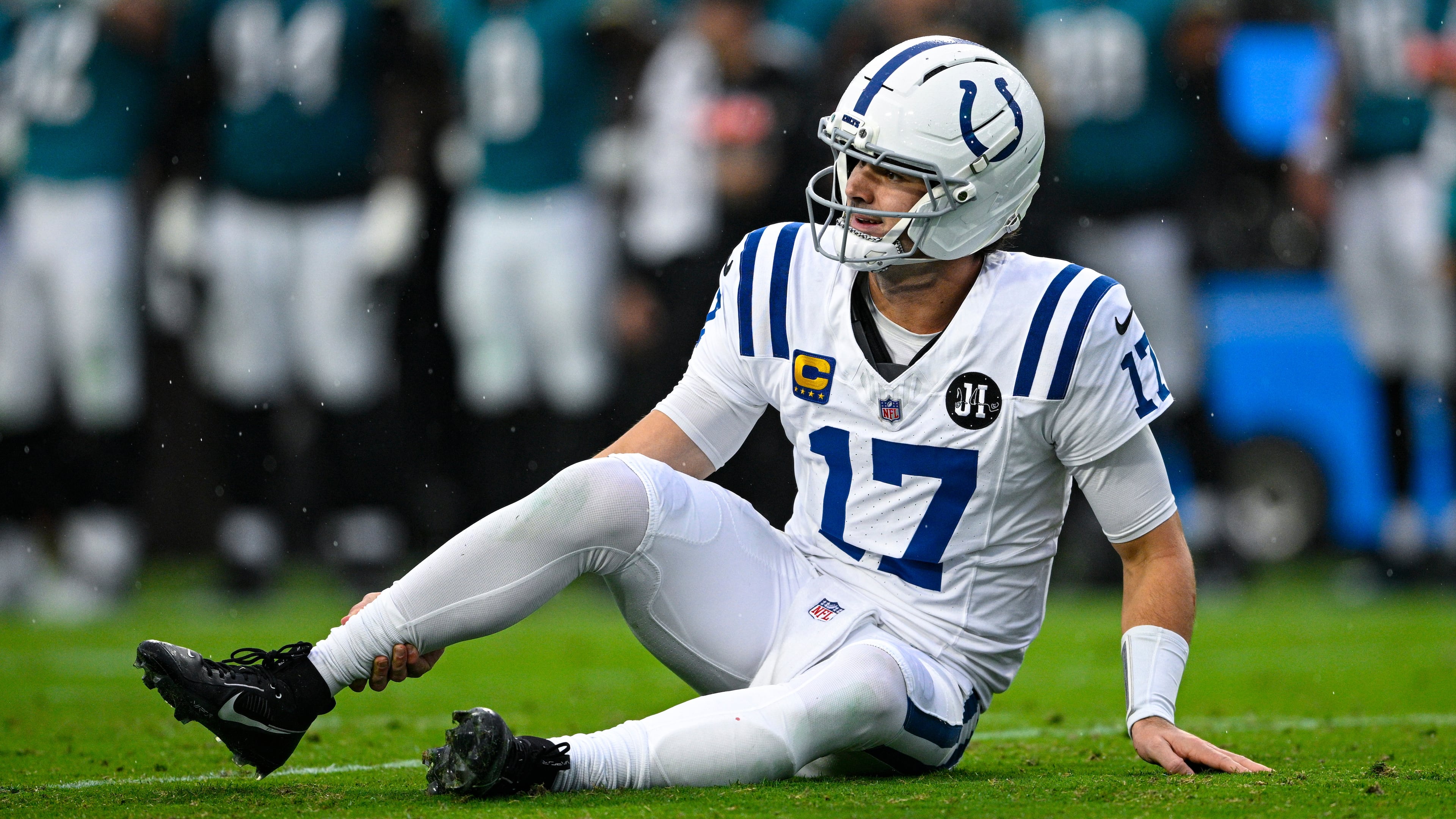 Indianapolis Colts quarterback Daniel Jones (17) grabs his leg after an injury during the first half of an NFL football game against the Jacksonville Jaguars, Sunday, Dec. 7, 2025, in Jacksonville, Fla. (AP Photo/Phelan M. Ebenhack)