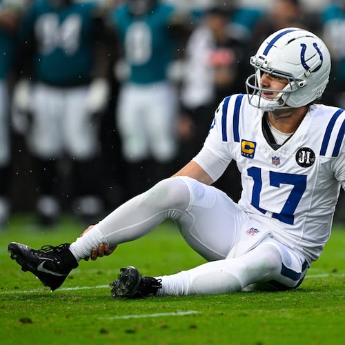 Indianapolis Colts quarterback Daniel Jones (17) grabs his leg after an injury during the first half of an NFL football game against the Jacksonville Jaguars, Sunday, Dec. 7, 2025, in Jacksonville, Fla. (AP Photo/Phelan M. Ebenhack)
