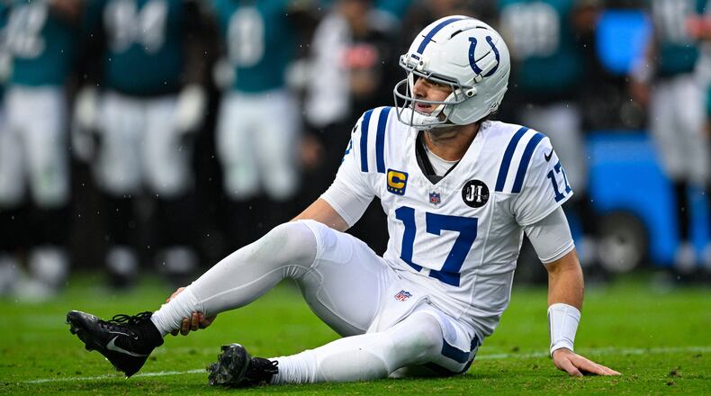 Indianapolis Colts quarterback Daniel Jones (17) grabs his leg after an injury during the first half of an NFL football game against the Jacksonville Jaguars, Sunday, Dec. 7, 2025, in Jacksonville, Fla. (AP Photo/Phelan M. Ebenhack)