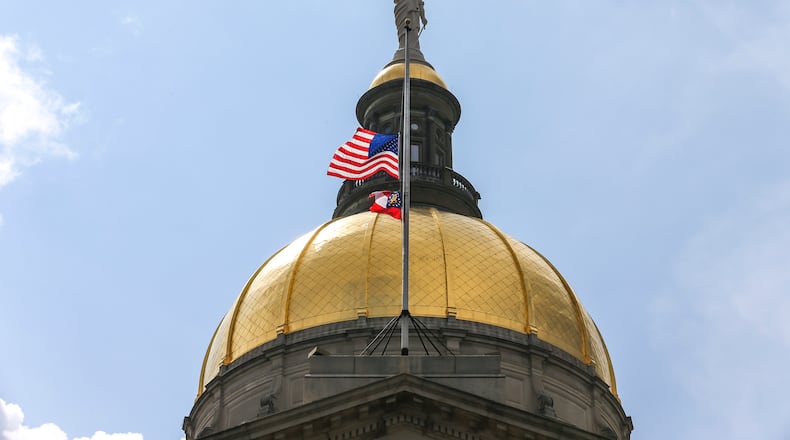 July 11, 2019  Atlanta : The United States and State of Georgia flags flew half-staff at the Georgia State Capitol on Thursday July 11, 2019 after Governor Kemp signed an executive order in memory of Hall County deputy Nicolas Dixon who was shot and killed. JOHN SPINK/JSPINK@AJC.COM