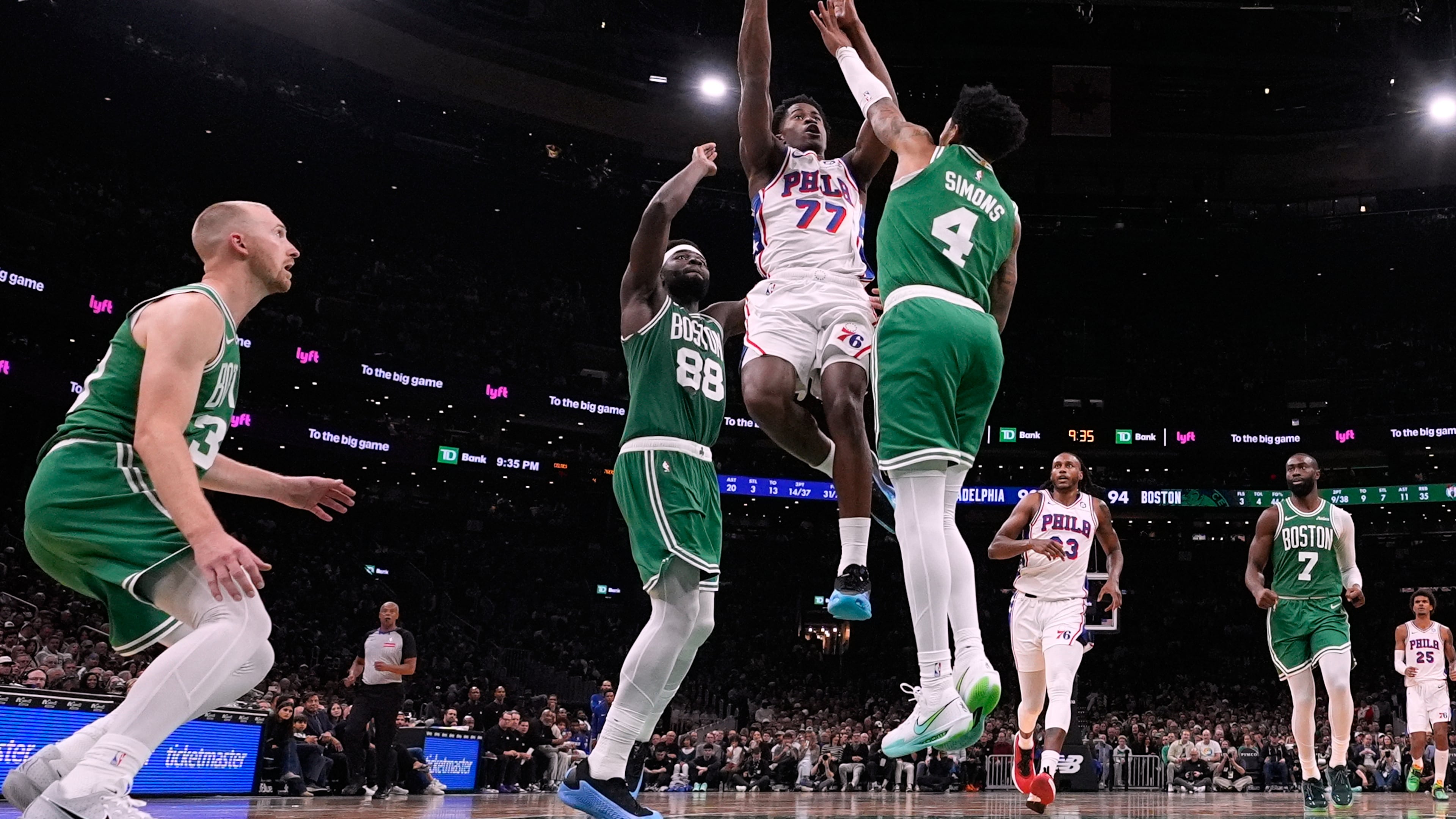 Philadelphia 76ers guard VJ Edgecombe (77) drives to the basket against Boston Celtics guard Anfernee Simons (4) during the second half of an NBA basketball game, Wednesday, Oct. 22, 2025, in Boston. (AP Photo/Charles Krupa)