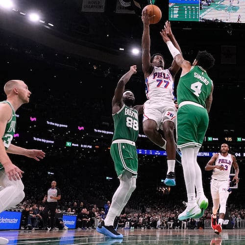 Philadelphia 76ers guard VJ Edgecombe (77) drives to the basket against Boston Celtics guard Anfernee Simons (4) during the second half of an NBA basketball game, Wednesday, Oct. 22, 2025, in Boston. (AP Photo/Charles Krupa)