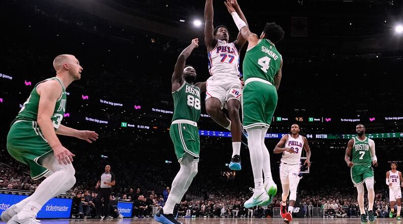 Philadelphia 76ers guard VJ Edgecombe (77) drives to the basket against Boston Celtics guard Anfernee Simons (4) during the second half of an NBA basketball game, Wednesday, Oct. 22, 2025, in Boston. (AP Photo/Charles Krupa)