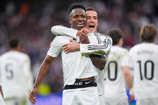 Real Madrid's Vinicius Junior celebrates with Real Madrid's Lucas Vazquez after scoring his side's second goal during the Spanish La Liga soccer match between Real Madrid and Rayo Vallecano at the Santiago Bernabeu stadium in Madrid, Spain, Sunday, March 9, 2025. (AP Photo/Manu Fernandez)