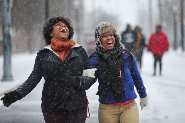 These ladies enjoyed the snow that snarled Atlanta in 2014. They're unlikely to see the white stuff next week.