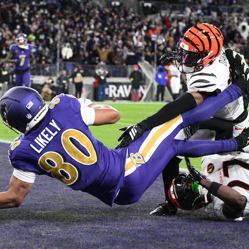 Baltimore Ravens tight end Isaiah Likely (80) fumbles the ball in the end zone as Cincinnati Bengals cornerback Jalen Davis (35) and Cincinnati Bengals safety Jordan Battle (27) defend during the first half of an NFL football game, Thursday, Nov. 27, 2025, in Baltimore. (AP Photo/Nick Wass)