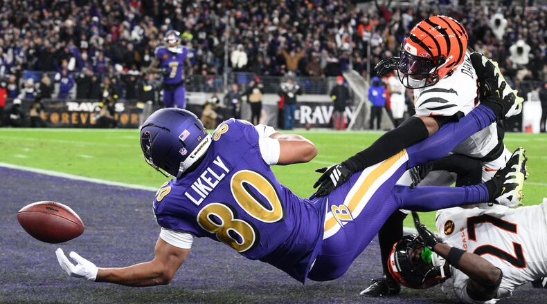 Baltimore Ravens tight end Isaiah Likely (80) fumbles the ball in the end zone as Cincinnati Bengals cornerback Jalen Davis (35) and Cincinnati Bengals safety Jordan Battle (27) defend during the first half of an NFL football game, Thursday, Nov. 27, 2025, in Baltimore. (AP Photo/Nick Wass)