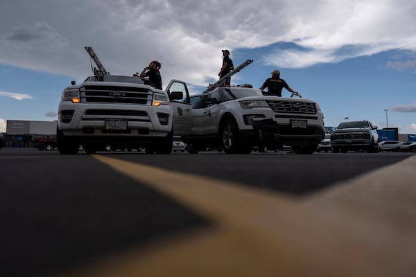 Members of the University of Colorado Boulder's Integrated Remote and In-Situ Sensing flight team stage in a Walmart parking lot before a Project ICECHIP operation Tuesday, June 3, 2025, in Atlus, Okla. (AP Photo/Carolyn Kaster)