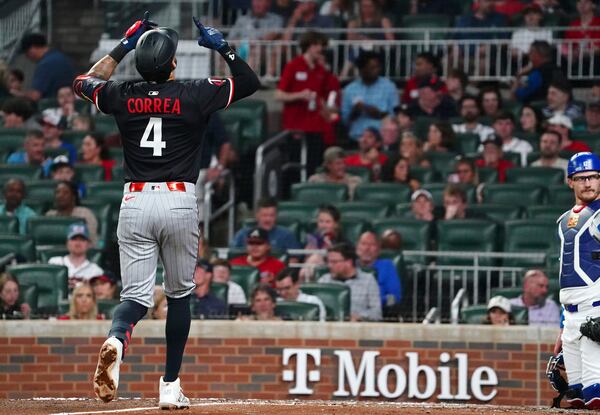 Minnesota Twins shortstop Carlos Correa (4) celebrates his solo homerun against the Atlanta Braves during the fourth inning in a baseball game at Truist Park, Saturday, April 19, 2025, in Atlanta. (AP Photo/ John David Mercer)