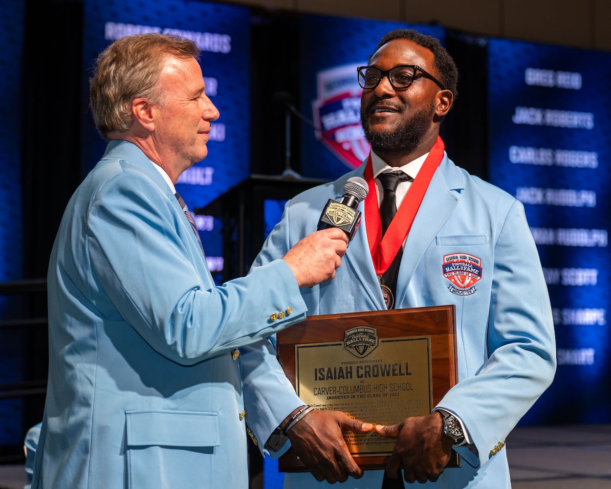 GPB Sports announcer Matt Stewart (left) interviews inductee Isaiah Crowell during a ceremony for the Georgia High School Football Hall of Fame Saturday, Oct. 25, 2025, at the College Football Hall of Fame in Atlanta. (Daniel Varnado for the AJC)