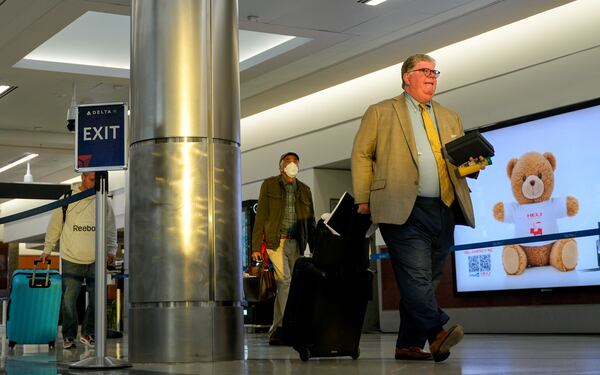 Travelers make their way through Hartsfield-Jackson Atlanta International Airport on Friday, Nov. 7, 2025. There were more than 75 Atlanta flights canceled Friday and more than 60 flights have been canceled for Saturday. (Ben Hendren for the AJC)