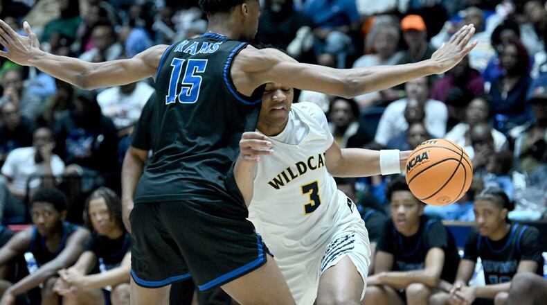 Wheeler's Colben Landrew (3) drives against Newton's RJ Wilson (15) during the first half of the GHSA Boys 6A State Championship at the Macon Centreplex, Saturday, March 8, 2025, in Macon. (Hyosub Shin / AJC)