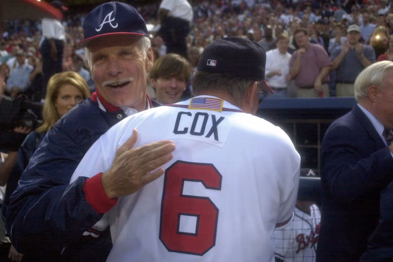 Longtime Braves owner Ted Turner (back) congratulates manager Bobby Cox on a win in the 2001 National League Division Series. (Marlene Karas/AJC 2001)
