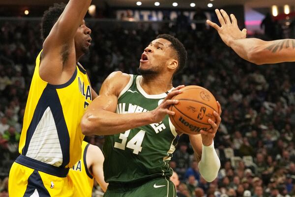 Milwaukee Bucks forward Giannis Antetokounmpo, right, drives against Indiana Pacers center Thomas Bryant, left, during the first half in Game 3 of an NBA basketball first-round playoff series Friday, April 25, 2025, in Milwaukee. (AP Photo/Nam Y. Huh)