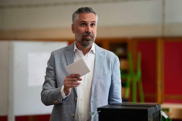 Socialist Party secretary general Pedro Nuno Santos holds his ballot when voting in Portugal's general election at a polling station in Lisbon, Sunday, May 18, 2025. (AP Photo/Armando Franca)