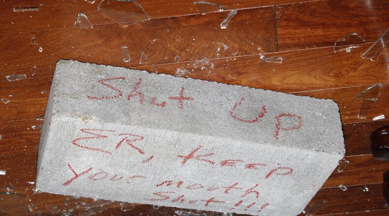 Crime scene photos from the Atlanta Police Department show a brick that landed in Elvin “E.R.” Mitchell’s home in southwest Atlanta in September 2015. Mitchell is a key figure in a federal criminal probe of city of Atlanta contracting.