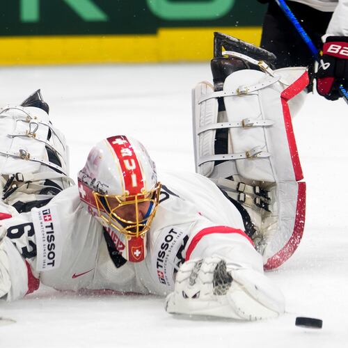 Switzerland's goaltender Leonardo Genoni reaches for the puck during a Group A preliminary round game between United States and Switzerland at the men's ice hockey world championship in Zurich, Switzerland, Friday, May 15, 2026. (Claudio Thoma/Keystone via AP)