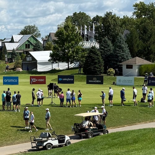 LIV Golf fans gather at the practice putting green before the final round of the season-ending event in suburban Indianapolis, Ind., Sunday, Aug. 23, 2026. (AP Photo/Michael Marot)