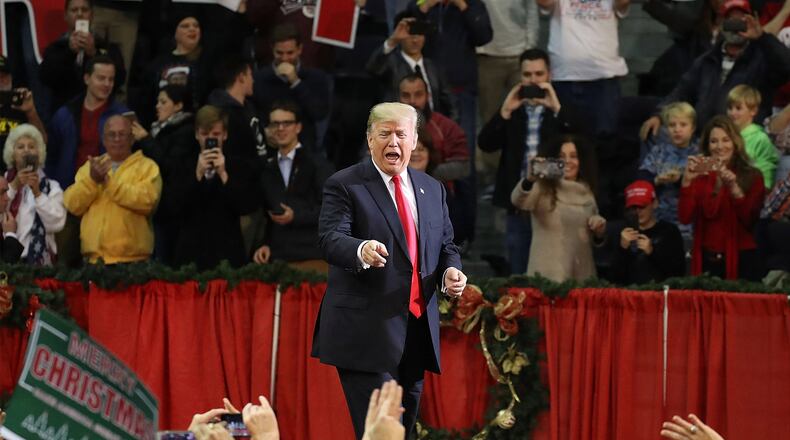 PENSACOLA, FL - DECEMBER 08: U.S. President Donald Trump walks on stage as he holds a rally at the Pensacola Bay Center on December 8, 2017 in Pensacola, Florida. Mr. Trump was expected to further endorse Alabama Republican Senatorial candidate Roy Moore who is running against Democratic challenger Doug Jones in the adjacent state. (Photo by Joe Raedle/Getty Images) *** BESTPIX ***