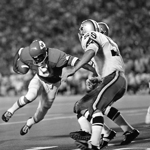 FILE - Warren McVea (6) Kansas City Chiefs running back is stopped on an end run by Dallas Cowboy Leroy Jordan (55) in the first quarter action in Dallas, Sept. 5, 1970. (AP Photo/Fred Kaufman,File)