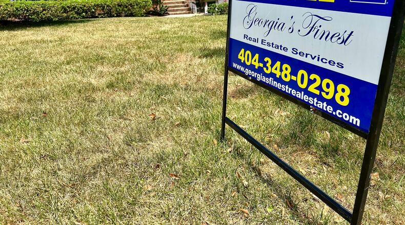 WIth many Atlantans heading for vacations -- and interest rates still high -- the housing market cooled as summer was arriving. Here, a Dunwoody home listed for sale in late June. J. Scott Trubey/scott.trubey@ajc.com.