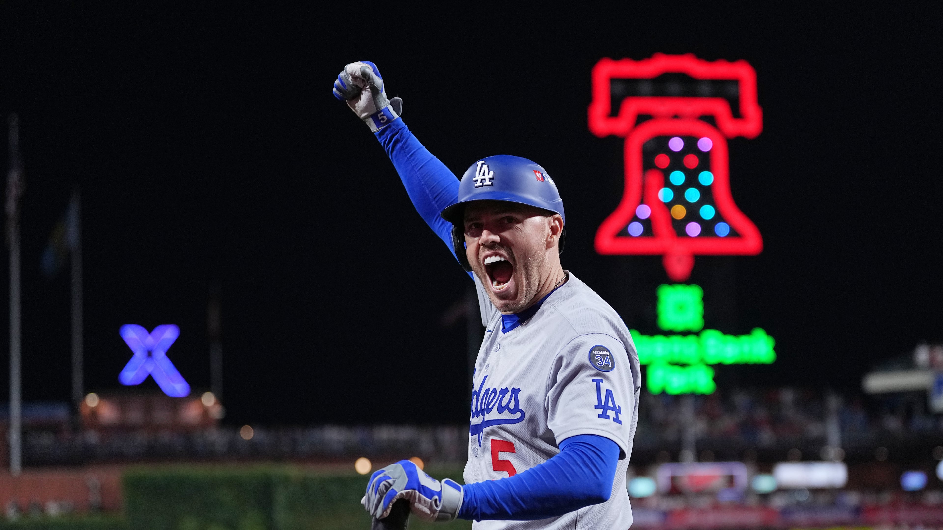 Los Angeles Dodgers' Freddie Freeman reacts after Teoscar Hernández hit a three-run home run off Philadelphia Phillies pitcher Matt Strahm during the seventh inning in Game 1 of baseball's National League Division Series, Saturday, Oct. 4, 2025, in Philadelphia. (AP Photo/Matt Rourke)