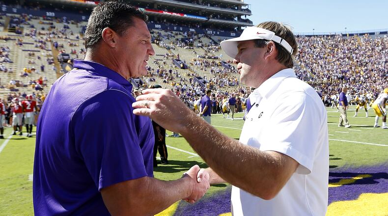 Head coach Ed Orgeron (L) of the LSU Tigers and head coach Kirby Smart of the Georgia Bulldogs meet on the field before a game at Tiger Stadium on October 13, 2018 in Baton Rouge, Louisiana. (Photo by Jonathan Bachman/Getty Images)