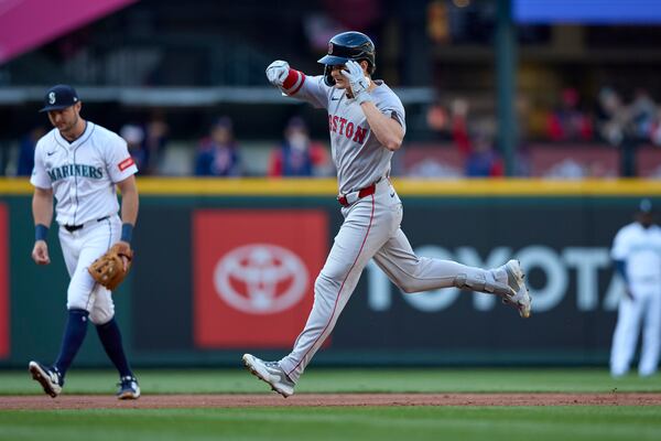 Boston Red Sox's Roman Anthony, center, rounds the bases on his solo home run off Seattle Mariners starting pitcher Logan Gilbert during the first inning of a baseball game Monday, June 16, 2025, in Seattle. (AP Photo/John Froschauer)