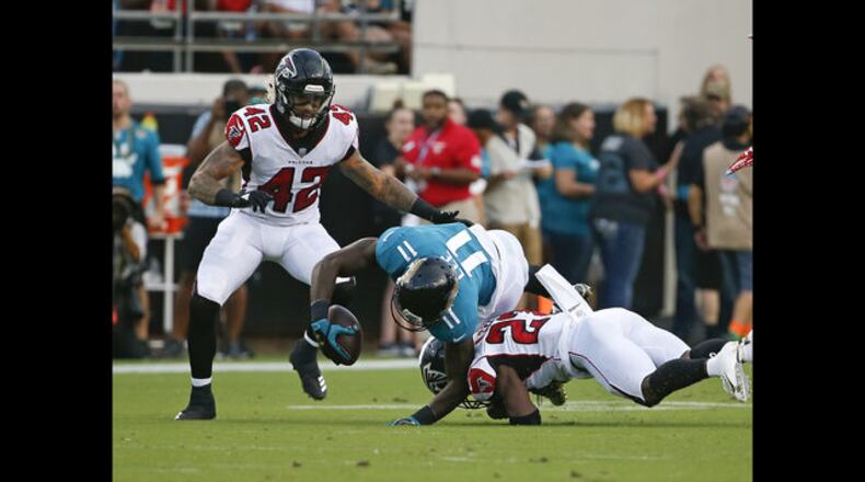 Jacksonville Jaguars wide receiver Marqise Lee (11) is injured as he is tackled by Atlanta Falcons cornerback Damontae Kazee, right, and linebacker Duke Riley (42) during the first half of an NFL preseason football game, Saturday, Aug. 25, 2018, in Jacksonville, Fla. Lee was taken off the field on an medical cart after the play. (AP Photo/Stephen B. Morton)