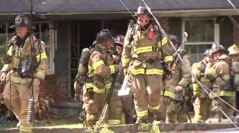 DeKalb County fire crews worked to extinguish a house fire after a tree knocked down power lines, officials said.
