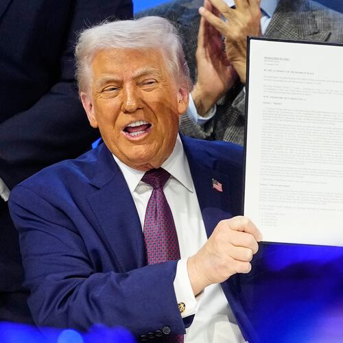 President Donald Trump holds the charter during a signing ceremony on his Board of Peace initiative at the Annual Meeting of the World Economic Forum in Davos, Switzerland, Thursday, Jan. 22, 2026. (AP Photo/Markus Schreiber)