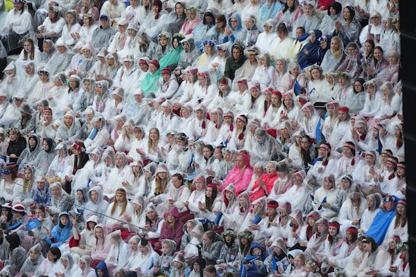 Choir singers take part in the Estonian Song Festival, part of the "Iseoma" Song and Dance Celebration, at the Song Festival Grounds in Tallinn, Estonia, Saturday, July 5, 2025. (AP Photo/Sergei Grits)