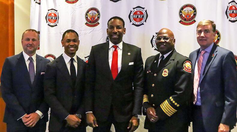 During a Breakfast with Our Bravest event, Atlanta Fire Rescue Foundation Board Chair Chris Sizemore (from left), Atlanta Fire Rescue Foundation president and CEO Taos Wynn, Atlanta Mayor Andre Dickens, Atlanta Fire Rescue Department chief Roderick M. Smith and Atlanta Track Club CEO Rich Kenah announced a new 5K race to benefit firefighters.