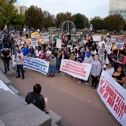People protest against federal immigration enforcement Saturday, Nov. 15, 2025, in Charlotte, N.C. (AP Photo/Erik Verduzco)