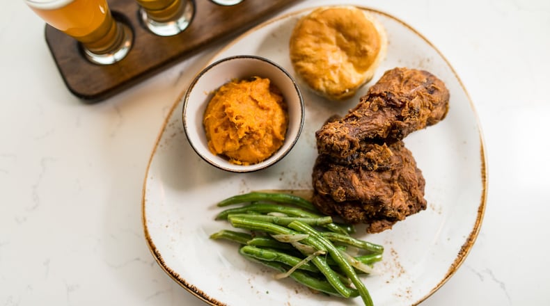 Southern fried chicken with molasses biscuit, braised green beans, and sweet potato mash and a local beer flight at Chicken + Beer. / Photo credit- Mia Yakel.