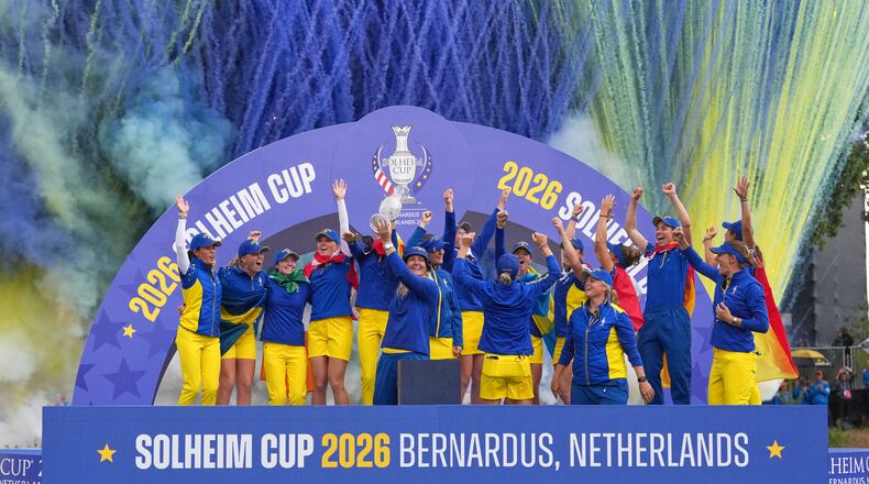 Anna Nordqvist Europe team captain holds the trophy aloft after her team won the Solheim Cup in Den Bosch, Netherlands, Sunday, Sept. 13, 2026. (AP Photo/Alastair Grant)