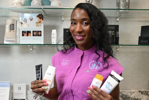 Georgia dermatologist Dr. Jessica Mercer holds sunscreens at Georgia Dermatology Partners on Friday, July 10, 2026, in Brookhaven. (Hyosub Shin/AJC)