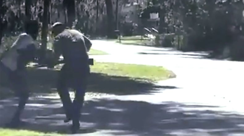 In this image from video posted on Twitter on May 5, 2020, Ahmaud Arbery, left, struggles with Travis McMichael over a shotgun on a street in a neighborhood outside Brunswick, Georgia, on Feb. 23, 2020. Arbery, who was jogging when he was confronted by McMichael and his father and shot multiple times. The 25-year-old died at the scene.