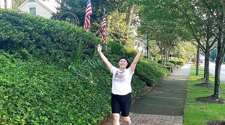Cecilie Benefield runs down Church Street in Marietta on July 4. Photo: Brian Benefield