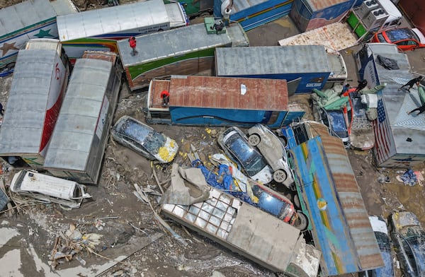 Damaged vehicles are seen after severe monsoon rains flooded the Bhotekoshi River and swept away a key bridge connecting the country with China at Rasuwagadi,120 kilometers (75 miles) north of the capital, Kathmandu, Nepal, Wednesday, July, 9, 2025. (AP Photo/Sujan Gurung)